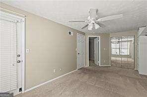 1371 Keys Lake Dr NE, Atlanta, GA 30319 - unfurnished living room with a ceiling fan and baseboards