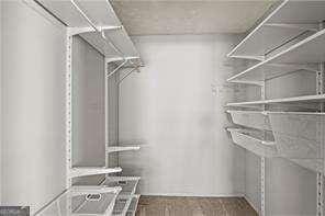 1371 Keys Lake Dr NE, Atlanta, GA 30319 - walk in closet featuring wood finished floors