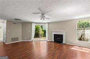 1371 Keys Lake Dr NE, Atlanta, GA 30319 - unfurnished living room featuring plenty of natural light, ceiling fan, and wood finished floors