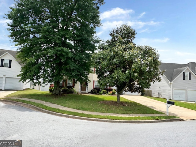 130 Hazelhurst Dr, Covington, GA 30016 - view of property hidden behind natural elements featuring a front lawn and concrete driveway