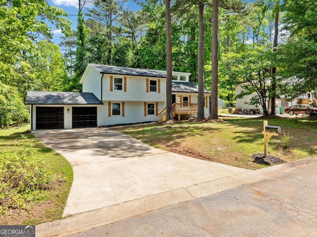 4058 Daron Ct, Ellenwood, GA 30294 - tri-level home featuring concrete driveway, an attached garage, and a front lawn
