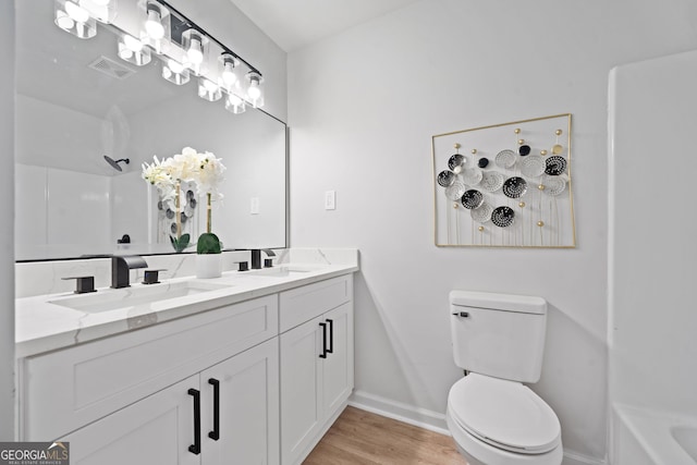 4058 Daron Ct, Ellenwood, GA 30294 - bathroom with toilet, baseboards, wood finished floors, a shower, and double vanity