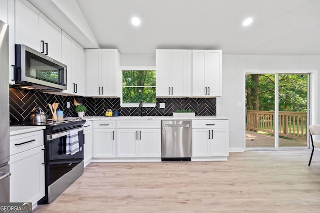 4058 Daron Ct, Ellenwood, GA 30294 - kitchen with appliances with stainless steel finishes, backsplash, light countertops, white cabinetry, and a sink