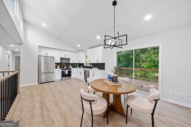 4058 Daron Ct, Ellenwood, GA 30294 - dining area with light wood-style flooring, a chandelier, baseboards, recessed lighting, and high vaulted ceiling