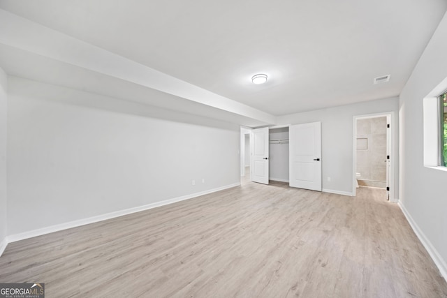 4058 Daron Ct, Ellenwood, GA 30294 - unfurnished bedroom featuring light wood-style flooring, baseboards, a closet, and connected bathroom