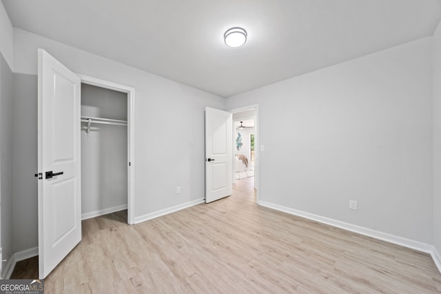 4058 Daron Ct, Ellenwood, GA 30294 - unfurnished bedroom featuring wood finished floors, baseboards, and a closet