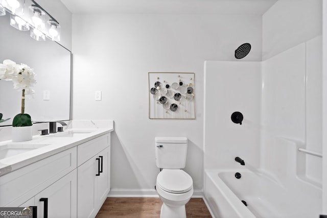 4058 Daron Ct, Ellenwood, GA 30294 - full bath featuring wood finished floors, toilet, baseboards, double vanity, and bathtub / shower combination