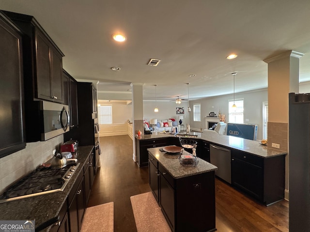 419 Woodmill Way SW, South Fulton, GA 30331 - kitchen with stainless steel appliances, a center island, dark wood-style flooring, tasteful backsplash, and recessed lighting