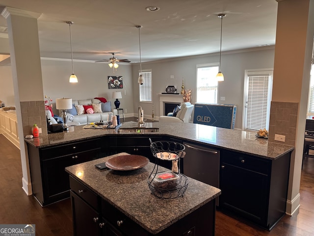 419 Woodmill Way SW, South Fulton, GA 30331 - kitchen featuring a sink, open floor plan, crown molding, a fireplace, and dark cabinets