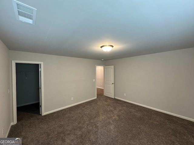 419 Woodmill Way SW, South Fulton, GA 30331 - unfurnished bedroom with dark colored carpet, a walk in closet, baseboards, and a closet