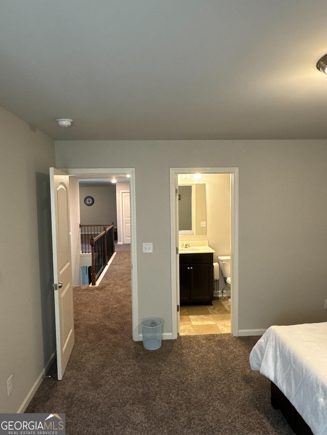 419 Woodmill Way SW, South Fulton, GA 30331 - bedroom with light carpet, a sink, baseboards, and connected bathroom