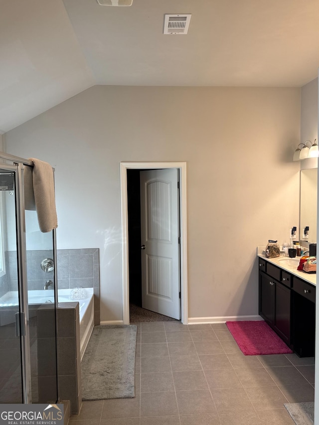 419 Woodmill Way SW, South Fulton, GA 30331 - bathroom featuring vaulted ceiling, tile patterned floors, a stall shower, a bath, and vanity