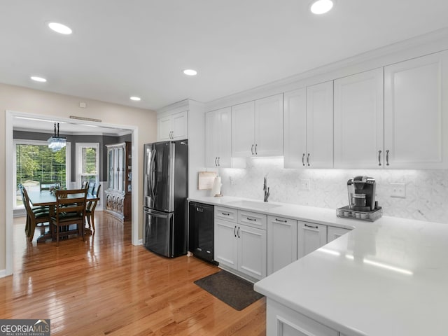 8117 Spivey Rd, Jonesboro, GA 30236 - kitchen featuring freestanding refrigerator, dishwasher, a sink, white cabinets, and tasteful backsplash