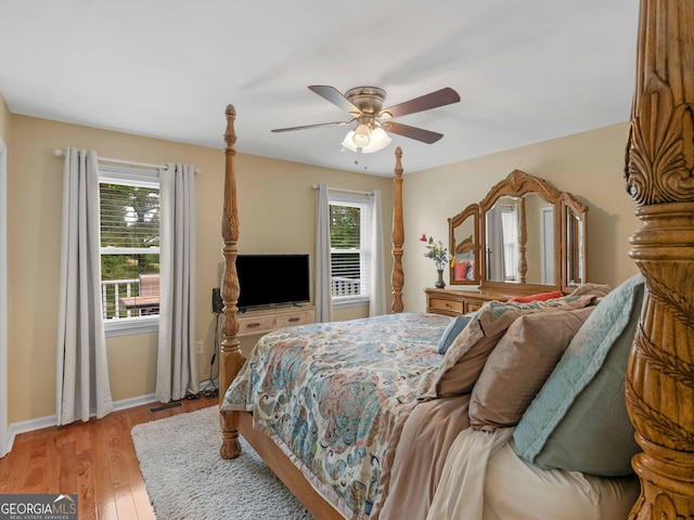8117 Spivey Rd, Jonesboro, GA 30236 - bedroom featuring multiple windows, light wood finished floors, baseboards, and a ceiling fan