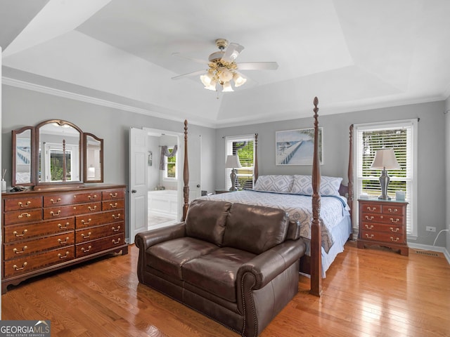 8117 Spivey Rd, Jonesboro, GA 30236 - bedroom with a raised ceiling, light wood-style floors, ornamental molding, connected bathroom, and ceiling fan