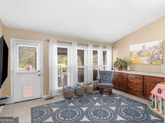 8117 Spivey Rd, Jonesboro, GA 30236 - sitting room with healthy amount of natural light, vaulted ceiling, and light tile patterned flooring