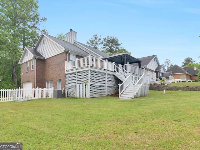 8117 Spivey Rd, Jonesboro, GA 30236 - back of property with a deck, a chimney, an attached garage, central AC unit, and brick siding