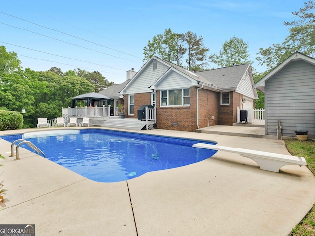 8117 Spivey Rd, Jonesboro, GA 30236 - view of pool with a gazebo, a wooden deck, a patio, and a diving board