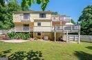 1202 Laurel Cliff Dr SE, Smyrna, GA 30082 - rear view of house featuring a lawn and a vegetable garden