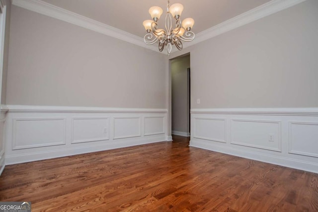 5995 Azalea Ridge Dr, Douglasville, GA 30135 - spare room with a chandelier, ornamental molding, a wainscoted wall, wood finished floors, and a decorative wall