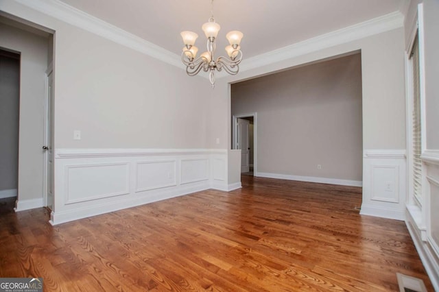 5995 Azalea Ridge Dr, Douglasville, GA 30135 - unfurnished dining area with a chandelier, ornamental molding, a wainscoted wall, and wood finished floors