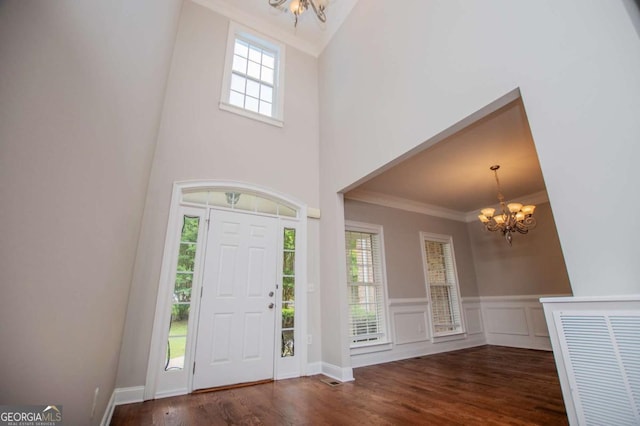 5995 Azalea Ridge Dr, Douglasville, GA 30135 - foyer with a chandelier, wood finished floors, crown molding, wainscoting, and a high ceiling