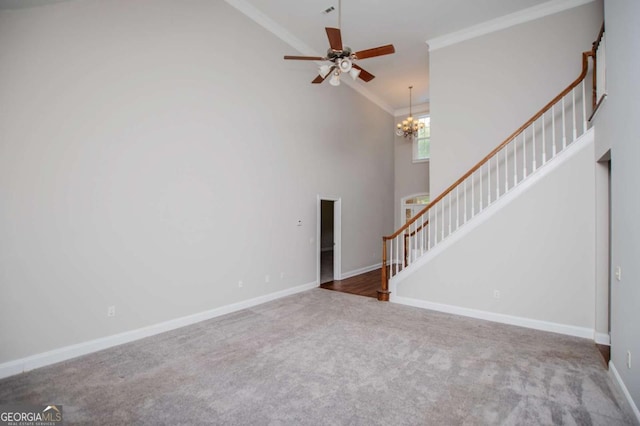 5995 Azalea Ridge Dr, Douglasville, GA 30135 - unfurnished living room with stairs, carpet floors, crown molding, high vaulted ceiling, and a chandelier
