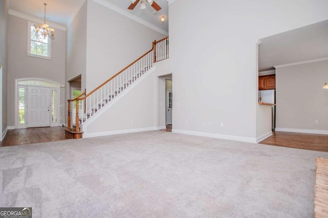 5995 Azalea Ridge Dr, Douglasville, GA 30135 - carpeted foyer entrance featuring stairs, crown molding, a chandelier, baseboards, and a ceiling fan