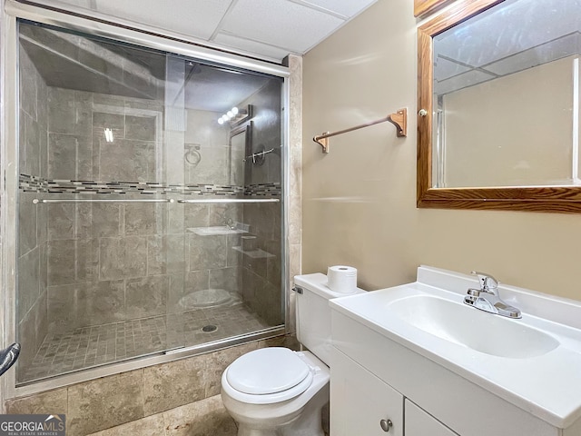 bathroom with a shower stall, toilet, and vanity