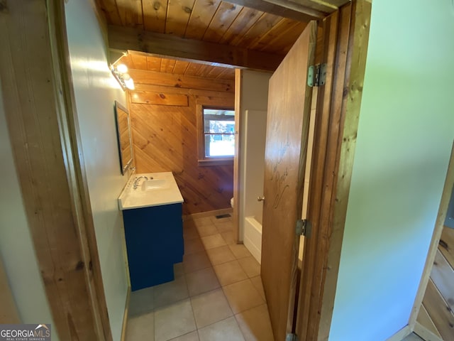 16 Tuts Mountain Rd, Clayton, GA 30525 - bathroom with vanity, wooden walls, wooden ceiling with exposed beams, toilet, and tile patterned floors
