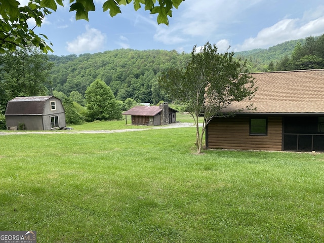 16 Tuts Mountain Rd, Clayton, GA 30525 - view of green lawn featuring a forest view and an outdoor structure