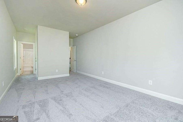 3018 Old Covington Rd Unit 3, Covington, GA 30014 - unfurnished bedroom featuring light carpet and baseboards