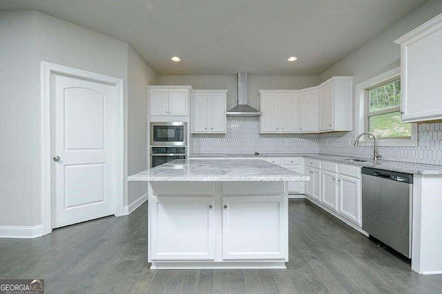3018 Old Covington Rd Unit 3, Covington, GA 30014 - kitchen featuring stainless steel appliances, wall chimney range hood, a sink, white cabinetry, and recessed lighting