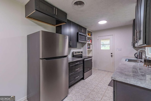 1902 Athens Hwy, Jefferson, GA 30549 - kitchen featuring stainless steel appliances, a textured ceiling, open shelves, and light stone countertops