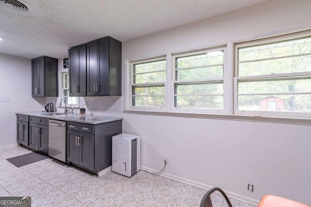 1902 Athens Hwy, Jefferson, GA 30549 - kitchen featuring stainless steel dishwasher, a textured ceiling, backsplash, and light stone counters