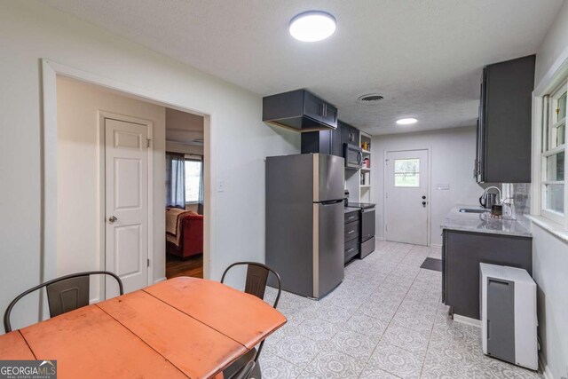 1902 Athens Hwy, Jefferson, GA 30549 - kitchen with stainless steel appliances, light countertops, and light tile patterned floors