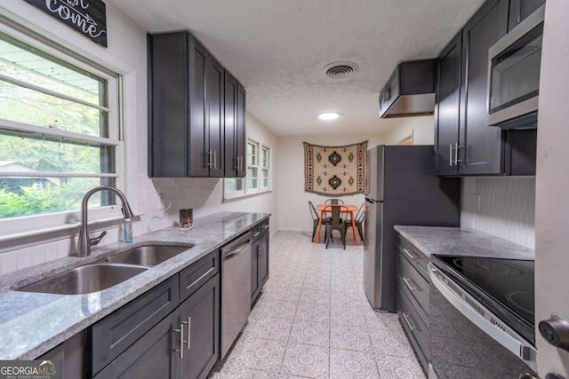 1902 Athens Hwy, Jefferson, GA 30549 - kitchen featuring appliances with stainless steel finishes, a textured ceiling, and light stone counters