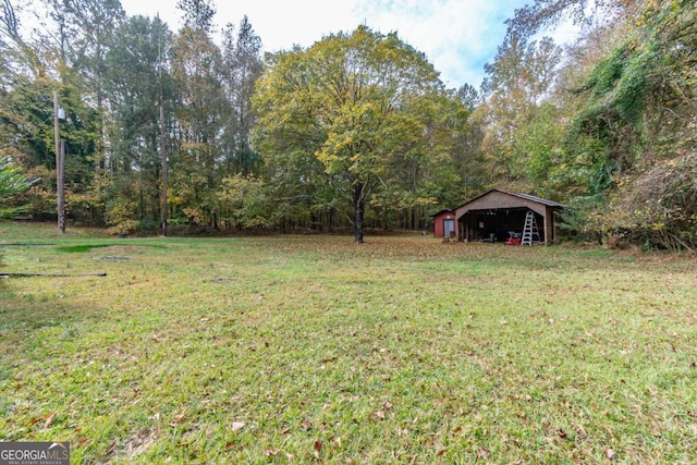 1902 Athens Hwy, Jefferson, GA 30549 - view of grassy yard with an outbuilding and a wooded view