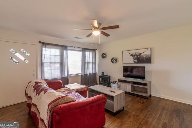 1902 Athens Hwy, Jefferson, GA 30549 - living area featuring a wood stove, ceiling fan, and dark wood-style floors
