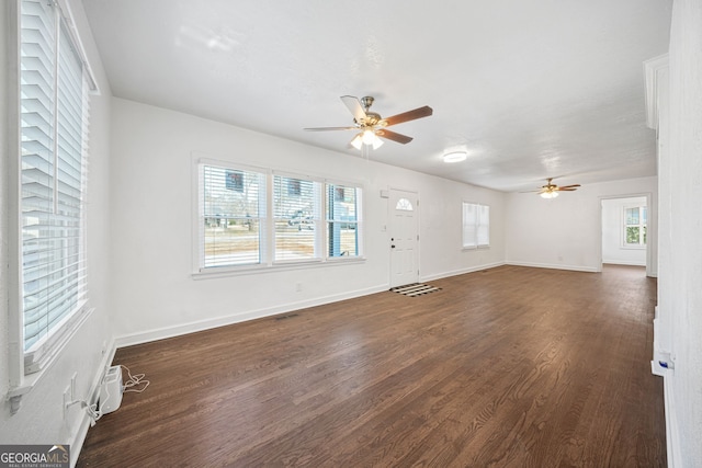 1831 Dresden Dr, Brookhaven, GA 30319 - unfurnished living room featuring a ceiling fan, dark wood-style flooring, and plenty of natural light