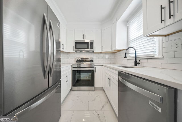 1831 Dresden Dr, Brookhaven, GA 30319 - kitchen with appliances with stainless steel finishes, a sink, light marble finish flooring, light stone countertops, and white cabinets