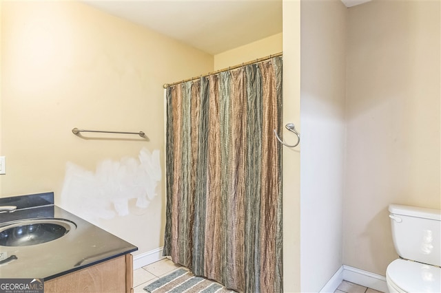full bathroom featuring tile patterned flooring, toilet, baseboards, and vanity