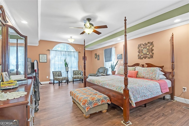 bedroom with wood finished floors, baseboards, crown molding, and recessed lighting