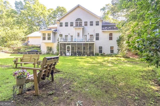 back of house with a sunroom and a yard