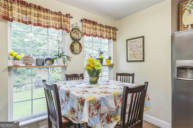 dining space featuring wood finished floors and baseboards
