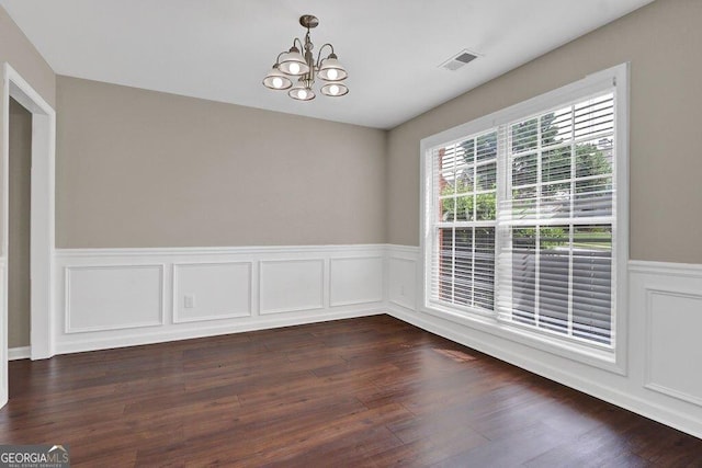 1280 Chandler Ridge Dr, Lawrenceville, GA 30045 - unfurnished dining area featuring a chandelier, a wainscoted wall, dark wood-style floors, and a decorative wall