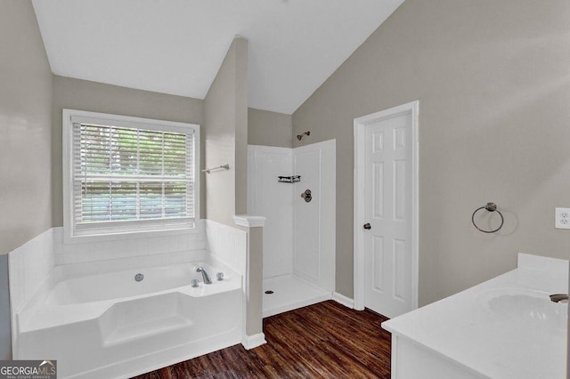 1280 Chandler Ridge Dr, Lawrenceville, GA 30045 - full bath with a bath, wood finished floors, walk in shower, vanity, and lofted ceiling