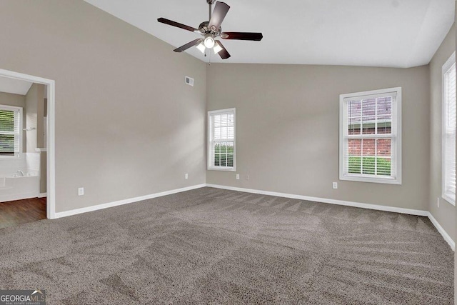 1280 Chandler Ridge Dr, Lawrenceville, GA 30045 - spare room featuring dark carpet, plenty of natural light, a ceiling fan, and high vaulted ceiling