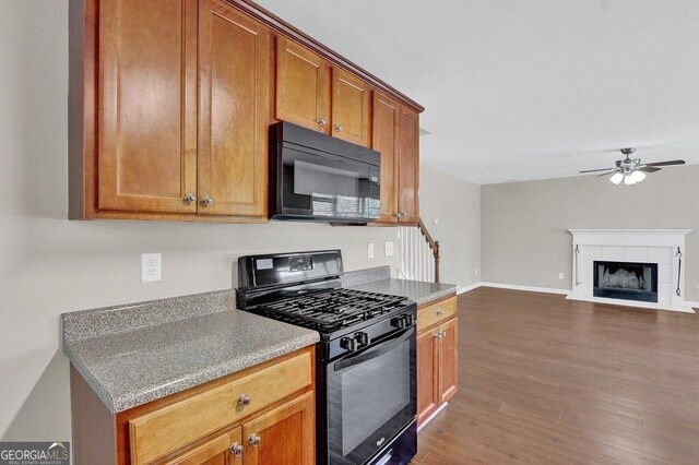 1280 Chandler Ridge Dr, Lawrenceville, GA 30045 - kitchen with black appliances, dark wood-type flooring, a ceiling fan, brown cabinetry, and open floor plan