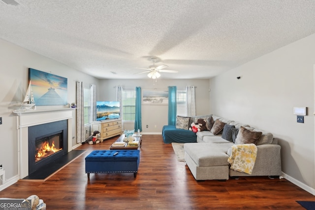 701 Fir Chase, Fairburn, GA 30213 - living area featuring a ceiling fan, a glass covered fireplace, a textured ceiling, wood finished floors, and baseboards
